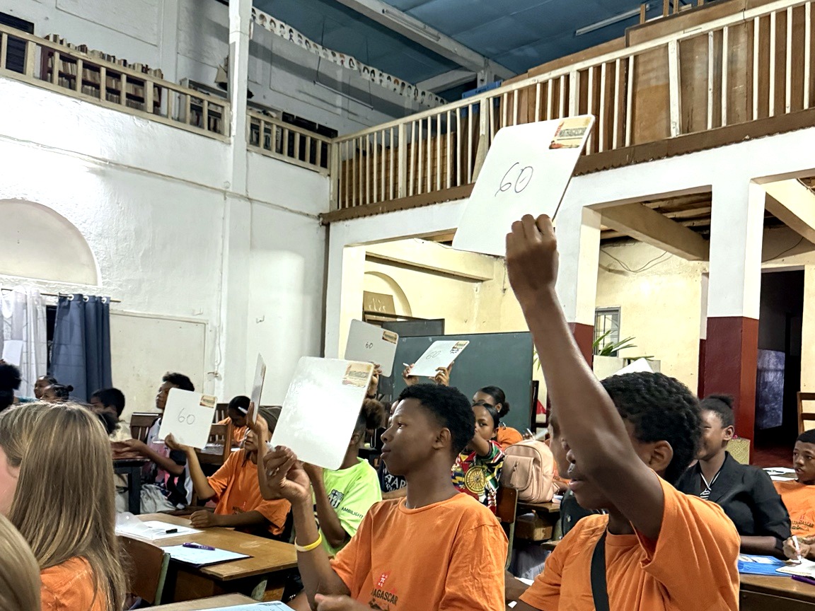 Students holding up whiteboards during an interactive maths quiz